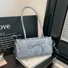 Bolsa texturizada para axila feminina, nova coleção primavera 2026, bolsa de ombro simples e estilosa para o dia a dia, bolsa de mão da moda para comércio exterior com detalhe de laço