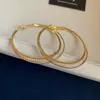 Pendientes europeos y americanos exagerados de estilo metálico, de doble capa entrelazada y tachonados de diamantes, modernos y versátiles, con un toque de lujo y elegancia de alta gama