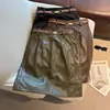 Foto real del nuevo modelo de otoño 2026: Falda bodycon de cuero PU de cintura alta estilo old money, línea A, para mujer, con abertura trasera y cinturón