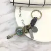 Llavero creativo punk para hombre y mujer, pequeño regalo, brújula de aleación, llavero de cuero tejido vintage, colgante para llaves