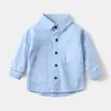 Camisa para Niños al por Mayor 2026 Nuevas Llegadas Camisa de Manga Larga para Niños Bebé Color Sólido Bolsillo con Parche Camisa de Moda Ropa para Niños Estilo Otoño