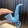Llavero de Juguete Musical de Saxofón Divertido Descompresión Estudiante Colgante Pequeño Colgante de Bolso Nuevo Regalo Pequeño Venta al por Mayor
