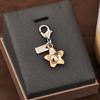 Colgante para llave de coche, bolso de gran sentido, accesorios de color dorado, oso, cereza, trébol de cuatro hojas, mariposa, bolso escolar, joyería al por mayor