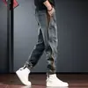 Calça Harem Cargo Patchwork Botões Estilo Americano Masculina Primavera e Outono Marca Tendência Solta Casual Jogger Jeans Tendência