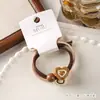Paquete de 2 Diademas para el Cabello de Gama Alta en Empaque de Tarjeta, Color Té con Leche Sencillo, Diademas con Forma de Oso, Dos en Uno, Bandas Elásticas Altas para Coletas
