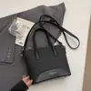 Bolso de mano tipo cubo nuevo de primavera 2026, transfronterizo, estilo vintage simple, de alta gama, moderno, para ir al trabajo, bolso de hombro cruzado de moda