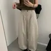 Foto real del nuevo artículo de moda coreana de otoño 2026 de Dongdaemun para mujer: pantalones casuales de moda con cintura elástica y estampado floral