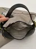 Nuevo modelo de principios de otoño 2026, bolso de media luna simple y elegante, diseño de nicho, color sólido único, sensación relajada, bolso de hombro para llevar debajo del brazo