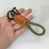 Colgante Llavero de Cuerda Exquisito Tejido a Mano con Logo Personalizado, Llavero de Cuero Genuino para Coche, Pequeño Regalo Universal al por Mayor