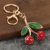 El llavero de cereza más vendido en AliExpress, simple y elegante, accesorio colgante de moda estilo ins para bolso de viajero