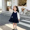 Vestido con Cuello de Muñeca Estilo Academia para Niñas 2026 Otoño Nuevo Llegada Overol Vestido de Manga Larga con Cuello de Muñeca para Niña Pequeña
