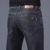 Jeans de alta gama para hombre para primavera y verano, corte recto, ajuste slim, elásticos, pantalones largos de moda de Guangzhou Xintang, estilo versátil de verano