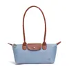 Bolso tipo baguette de mango largo estilo francés para el antebrazo, nuevo modelo 2026, bolso de hombro individual de nailon tipo bollo, diseño de nicho, bolso de boliche estilo coreano