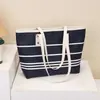 Bolso tote tipo cubo a rayas de alta gama para mujer, nuevo, elegante, versátil, de un solo hombro, cruzado, para llevar debajo del brazo