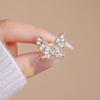 Broche de mariposa hueco con diamantes brillantes, pasador de seguridad anti-luz, decoración fija para cárdigan, bufanda