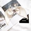 Accesorio para el cabello con clip de resorte y colgante de lazo grande estilo retro francés para mujer, elegante y de alta gama, con placa para la cabeza trasera.