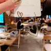 Aguja de plata 925 puesto mercado nocturno suministro aretes moda mujer asimétricos populares explosiones japonesas y coreanas aretes al por mayor A