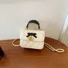 Mini bolso infantil 2026 otoño/invierno acolchado dulce cuadrado pequeño bolso de moda lazo padre-hijo PU bandolera