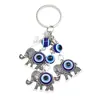Nuevo llavero transfronterizo con colgante de elefante, palmera y pavo con ojos azules, para bolso o coche.