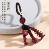 Al por mayor Mineral Crudo Natural Alto Contenido Cinabrio Oro Púrpura Torre Wen Chang Llavero de Bolígrafo Accesorios de Colgante para Bolsos Creativos Culturales Tendencia Nacional Más Vendidos