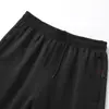 Pantalones Deportivos de Seda Surcoreanos de Primavera y Otoño, Pantalones de Chándal Casuales de Pierna Recta para Hombres, Mujeres y Niños en Negro Puro y Blanco Venta al por Mayor