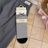 Calcetines de encaje dulces en blanco y negro estilo coreano para mujer, nuevos calcetines de otoño e invierno con lazo y volantes hasta la mitad de la pantorrilla, calcetines apilados sin costuras