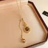 Otoño Invierno Estilo Retro Zircón Ojo de Tigre Cuenta Redonda Borla Collar Cadena Versátil para Suéter Lujo Ligero Sensación de Alta Gama Joyería Collar Venta al por Mayor