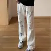 Calça jeans masculina preta rasgada e adornada com strass, com padrão de cruz, estilo reto moderno, levemente alargada, comprida, rasgada e adornada com strass