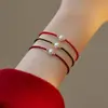 Vendedor recomenda Pulseira de Ano Novo com Corda Vermelha da Sorte de Pérola de Água Doce Quase Redonda 2022 Novo Design de Nicho Corda de Mão