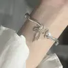 Pulsera de Lazo con Cascabel y Ola para Mujer, Diseño de Nicho, Pulsera de Moda Bañada en Plata, Joyería de Mano Versátil Estilo Ins al por Mayor