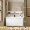 Tocador de baño engrosado y ahorrador de espacio con diseño en color crema, que cuenta con un lavabo redondeado, lavabo cerámico integrado y un lavabo de una sola pieza.