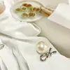 Estilo socialité Xiaoxiang Botón hueco de perla Botón de mariposa de aleación Abrigo de tweed con perlas Suéter Botón decorativo para mujer