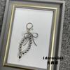 Nuevo en stock, venta al por mayor, colgante de bolso de amor con cuentas hecho a mano con lazo coreano, exquisito y versátil llavero para coche
