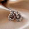 Pendientes geométricos exagerados transfronterizos europeos y americanos, pendientes de metal con giro sinuoso, pendientes de aro retro, círculo dorado plateado