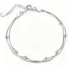 Pulsera en capas de cadena de clip con colgante de cruz minimalista transfronteriza europea y americana, una pulsera de estilo de lujo moderno y discreto para mujer