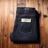 Estação europeia fornecimento ao cliente calças masculinas grossas quentes com forro de fleece cor primária micro elástico macio reto jeans com forro de fleece preto