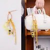Novo Pingente de Bolsa Série Amarela Miu Super Fofo Nicho Simples Versátil Chaveiro Bolsa Tecida Cordão Multicor