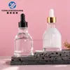 Botella redonda de hombro de 50 ml para aceite esencial con gotero de cuello largo, botella dispensadora de vidrio transparente, material de empaque para productos de cuidado de la piel, en stock