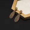 Pendientes Amazon transfronterizos, extragrandes, electrochapados, elegantes, de estilo largo, con un toque de alta gama, adornados con borlas y pedrería negra