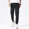 Pantalones casuales de malla fina de seda helada para el verano 2021 para hombre, tobilleros holgados tipo harén, estilo Hong Kong, ropa de trabajo, deportivos, con cordón en el tobillo, moda