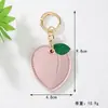 Chaveiro de Frutas Fofo Cereja Maçã Pêssego de Couro com Pingente Capa Protetora para Airtag Charme de Bolsa Venda Quente Transfronteiriça
