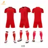 Conjunto de jersey de fútbol de secado rápido en stock, uniforme de entrenamiento para club escolar, corte holgado de manga corta, tallas grandes, jersey estampado por transferencia de calor, venta al por mayor