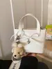 Bolsa de mão de nicho com laço para mulheres, novo modelo 2026, bolsa tipo saco com textura de couro oleado, bolsa transversal moderna para o dia a dia e para o trabalho