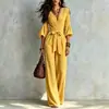 Macacão de outono estilo francês com decote V, calças pantalona, mangas bufantes, amarração na cintura, cintura alta, modelagem que afina, comprimento longo