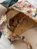 Bolsa de lona de gran capacidad para mujer, nuevo modelo 2026, estilo commuter de alta gama, estampado floral dulce, bolso tote de un solo hombro para llevar debajo del brazo