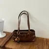 Bolso minimalista retro marrón de moda para mujer, nuevo bolso de hombro para el trabajo 2026, bolso de mano de venta caliente para otoño e invierno