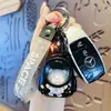 Original mochila escolar con luz oso astronauta llavero caricatura astronauta luminoso pareja mochila colgante regalo pequeño