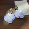 Nuevos aretes de flor de gardenia estilo chino para mujer, ambiente de verano junto al mar, aretes frescos y únicos