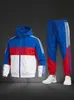 Fornecimento Direto da Fábrica Conjunto Esportivo Casual Masculino, Jaqueta Corta-Vento com Capuz Color Block e Calça Jogger Moletom Conjunto de Duas Peças