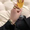 Conjunto de Pulsera y Anillo de Serpiente Cascabel con Goteo de Aceite Chapado en Cobre Oro de 18 Quilates Incrustado con Circonita Nuevo Ingreso de Lujo de Nicho Transfronterizo Europeo y Americano